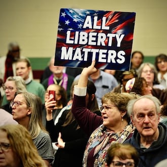 An audience member holds up a sign at a faith event supporting Haitians at St. John Missionary Baptist Church Monday, Feb. 2, 2026. Contributed photo Buck Creek Photography