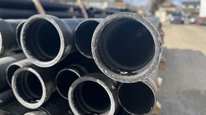 Water pipes stacked up on Bierce Avenue in East Dayton. Some local cities say they have a long wait for ductile iron pipes. CORNELIUS FROLIK / STAFF