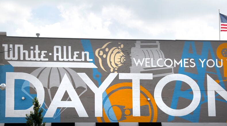 Welcoming commuters to Dayton is a mural spanning the length of the White Allen body shop, 442 N. Main Street. The artwork, a collaboration with local artist Amy Deal and K12 Gallery & TEJAS, celebrates the innovative history of the city. LISA POWELL / STAFF