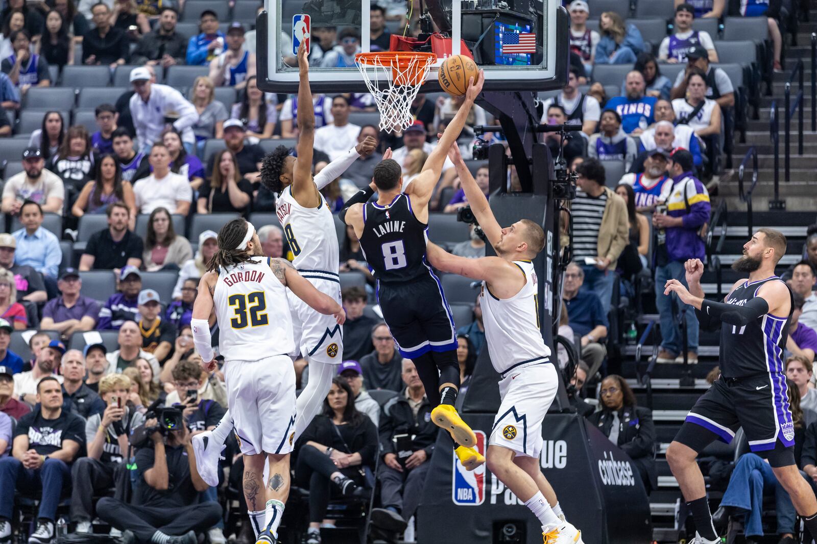 Sacramento Kings guard Zach LaVine (8) goes up for a layup as Denver Nuggets forward Peyton Watson (8) defends during the first half of an NBA basketball game Wednesday, April 9, 2025, in Sacramento, Calif. (AP Photo/Sara Nevis)