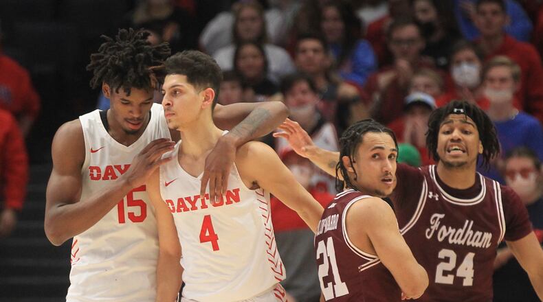 Dayton's Daron Holmes II, left, talks to Koby Brea during a game against Fordham on Tuesday, Jan. 25, 2022, at UD Arena. David Jablonski/Staff
