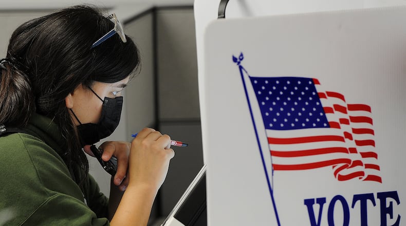 Victoria Mohr, looks over her ballot while early voting Thursday, Oct. 28, 2021 at the Board of Elections. MARSHALL GORBY\STAFF