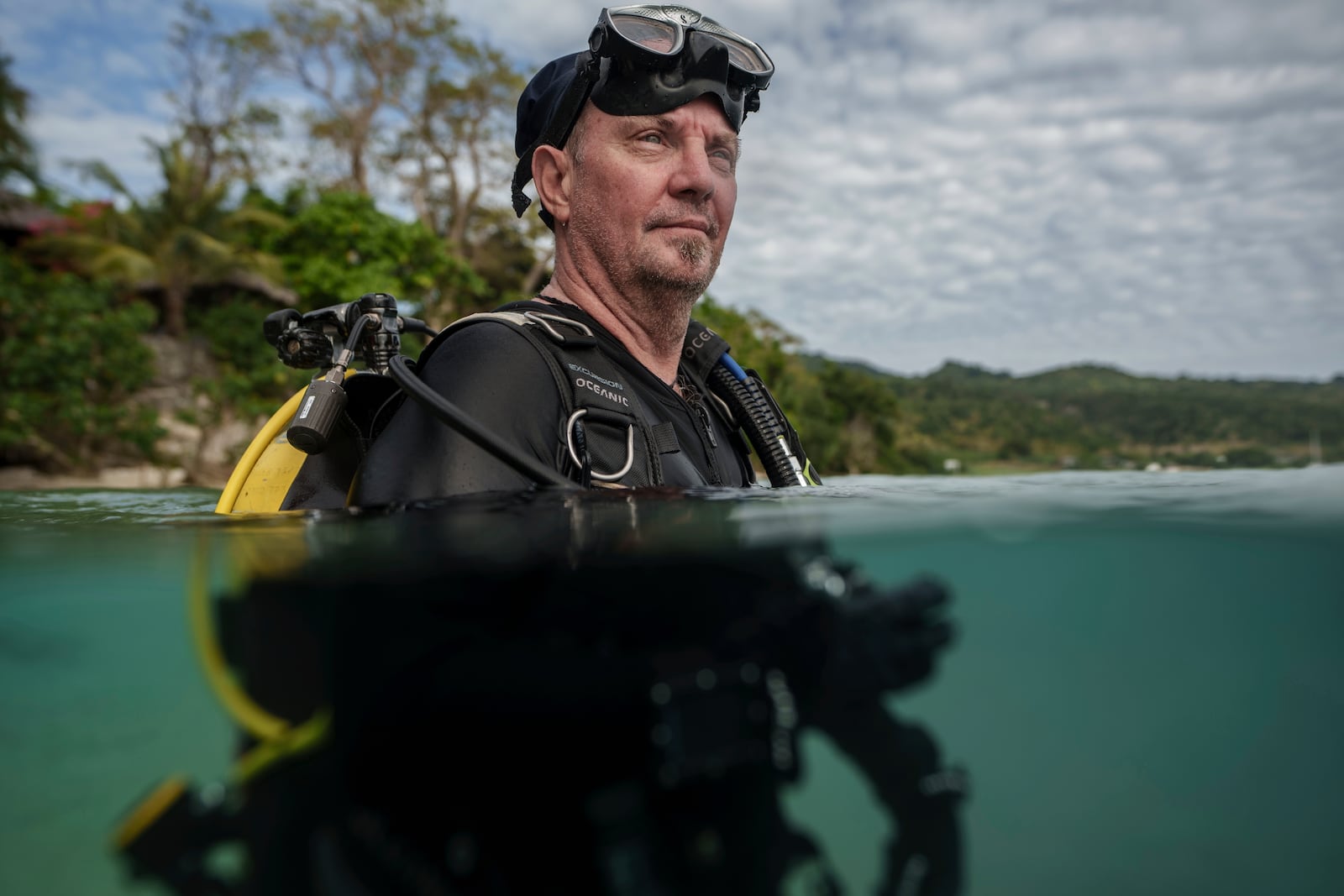 John Warmington, who has has dived the same patch of reef in Havannah Harbour, off the coast of Efate Island, Vanuatu, more than a thousand times, poses for a photo Sunday, July 20, 2025. (AP Photo/Annika Hammerschlag)