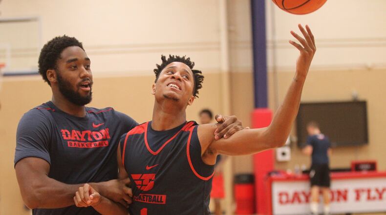 Dayton’s Josh Cunningham and Darrell Davis joke around as they warm up for practice on Thursday, Sept. 21, 2017, at the Cronin Center in Dayton. David Jablonski/Staff