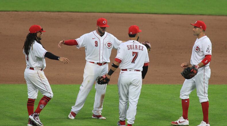 The Reds celebrate after beating the Tigers on Opening Day on Friday, July 24, 2020, at Great American Ball Park in Cincinnati. David Jablonski/Staff