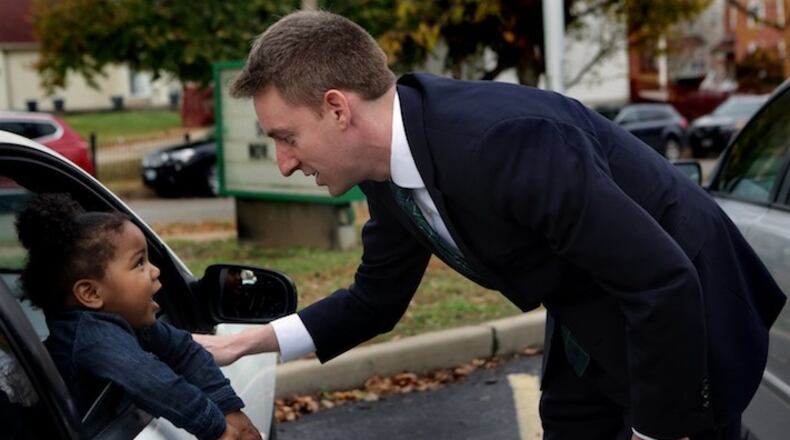 Democratic candidate for U.S. Senate Jason Kander talks with Teh'Riyah Hinkel, 1, after thanking her aunt for coming out to vote on November 8, 2016, in St. Louis. (Laurie Skrivan/St. Louis Post-Dispatch/TNS)