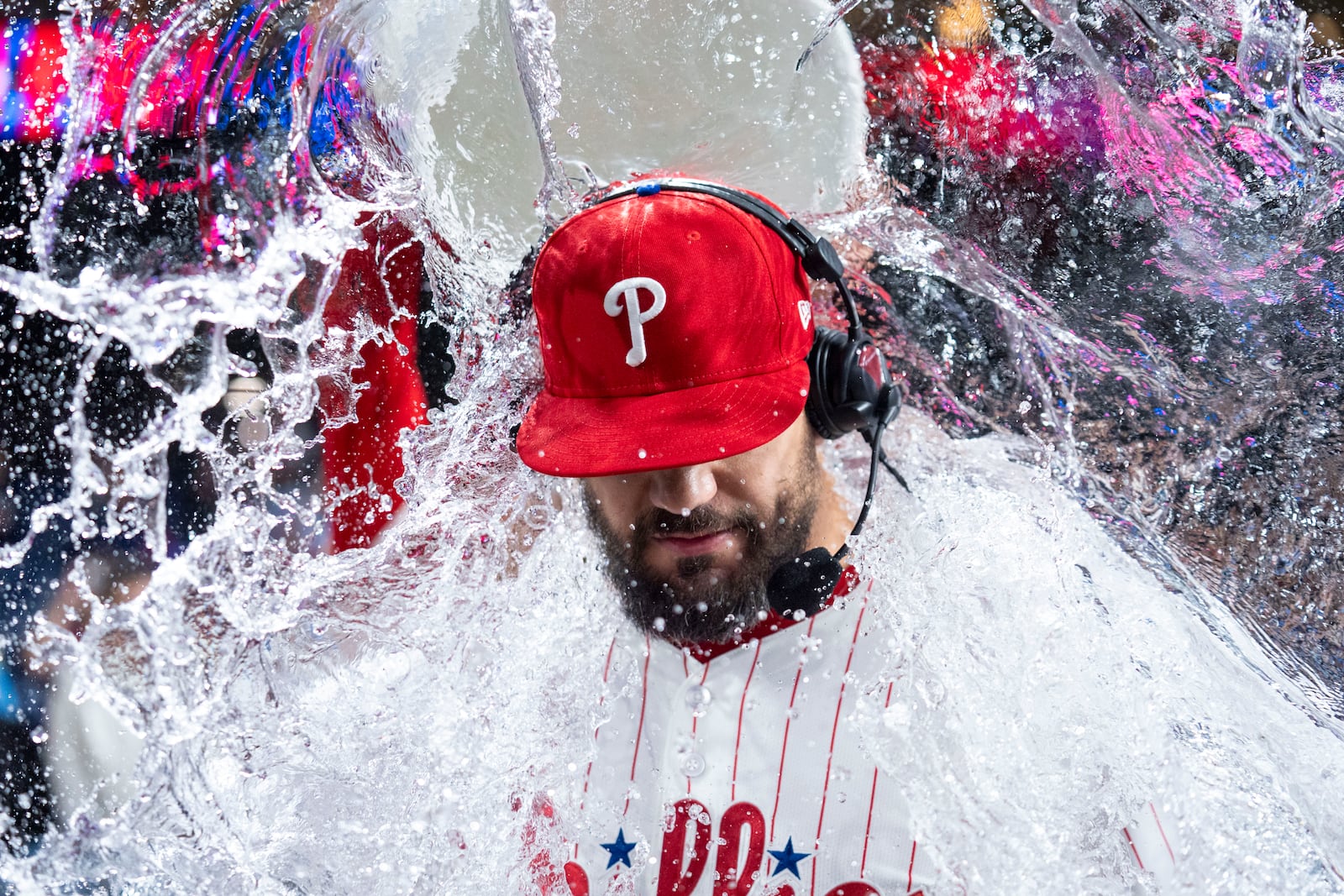 Philadelphia Phillies' Kyle Schwarber, gets doused with water as he is giving a post game interview following a baseball game against the New York Mets, Tuesday, Sep. 9, 2025, in Philadelphia. (AP Photo/Chris Szagola)