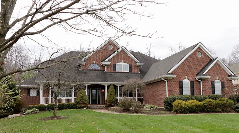 The brick 2-story has about 7,650 sq. ft. of living space within three levels. The house sits well off the road with a concrete driveway that leads to a 5-car, side-entry garage. CONTRIBUTED PHOTO BY KATHY TYLER