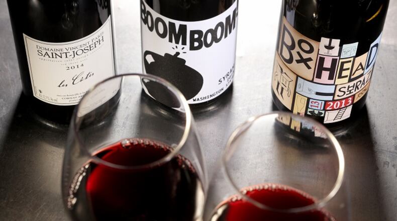 Syrah in the bottle might be called that on the label, or maybe shiraz, or maybe the grape isn't named at all. Here we see syrah-based wines from Saint-Joseph in France, from left, Washington state and Australia. (Michael Tercha/Chicago Tribune)