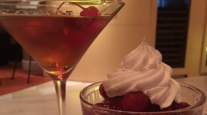 The gingerbread trifle ($6) combining gingerbread cake, sweetened cream cheese and bourbon cherries and a Manhattan at Mela Urban Bistro in the Courtyard by Marriott in downtown Springfield.CONTRIBUTED PHOTO BY ALEXIS LARSEN