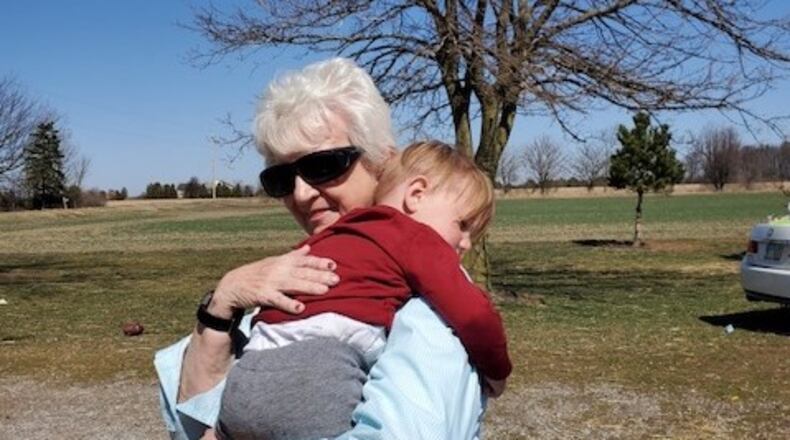 Marie Trittschuh hugs her 2-year-old great-grandson Harper Kosicki last weekend. They haven't seen each other throughout the pandemic except for the two funerals of Trittschuh's children, Harper's grandma and great-uncle who died from COVID-19.