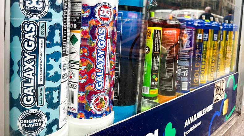 Canisters of Galaxy Gas and other nitrous oxide products on display at a smoke shop in Manhattan on Wednesday, Sept. 25, 2024. Nitrous oxide, which has been misused as a recreational drug for decades, has a new name on social media: Galaxy Gas. (The New York Times)
