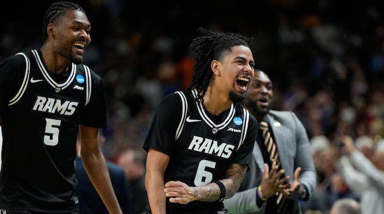 Virginia Commonwealth guard Terrence Hill Jr. (6) and Virginia Commonwealth forward Barry Evans (5) reacts after overtime in the first round of the NCAA college basketball tournament, Thursday, March 19, 2026, in Greenville, S.C. (AP Photo/Brynn Anderson)