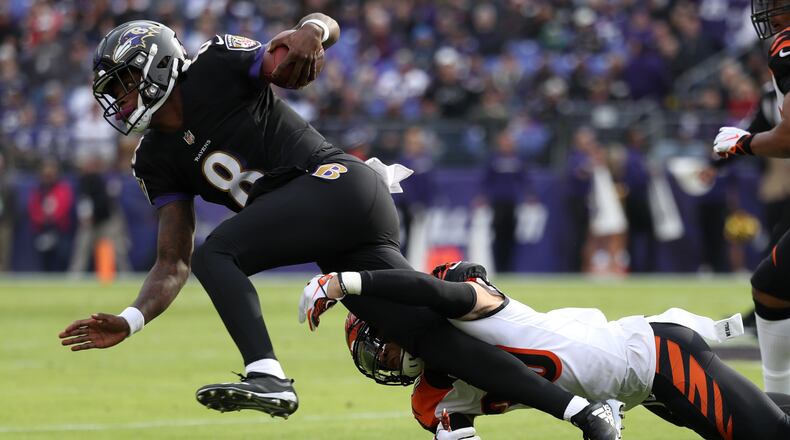 BALTIMORE, MD - NOVEMBER 18: Quarterback Lamar Jackson #8 of the Baltimore Ravens is tackled as he carries the ball by free safety Jessie Bates #30 of the Cincinnati Bengals in the first quarter at M&T Bank Stadium on November 18, 2018 in Baltimore, Maryland. (Photo by Rob Carr/Getty Images)