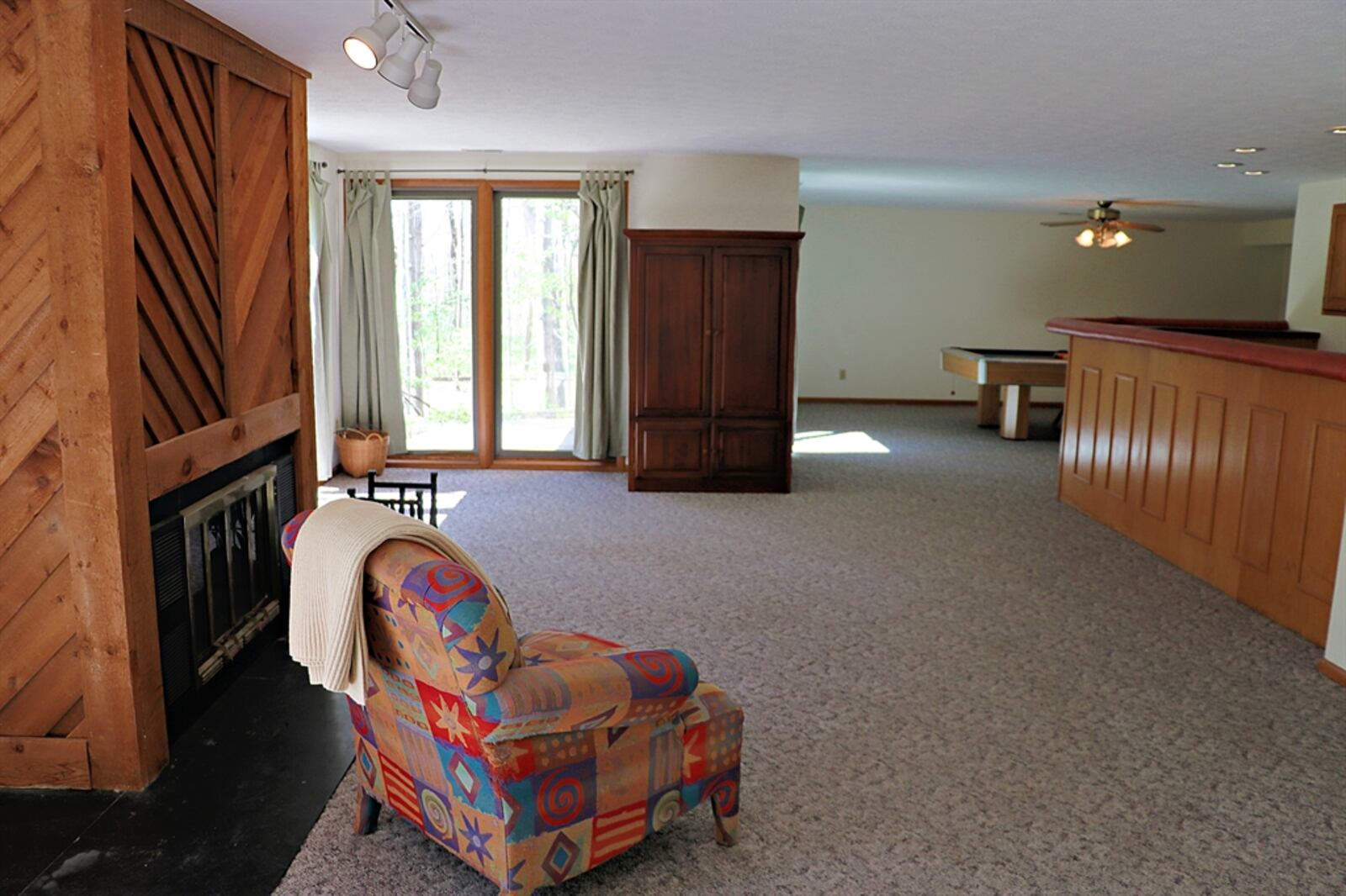 Sliding patio doors off the family room open out to a screen-enclosed deck.