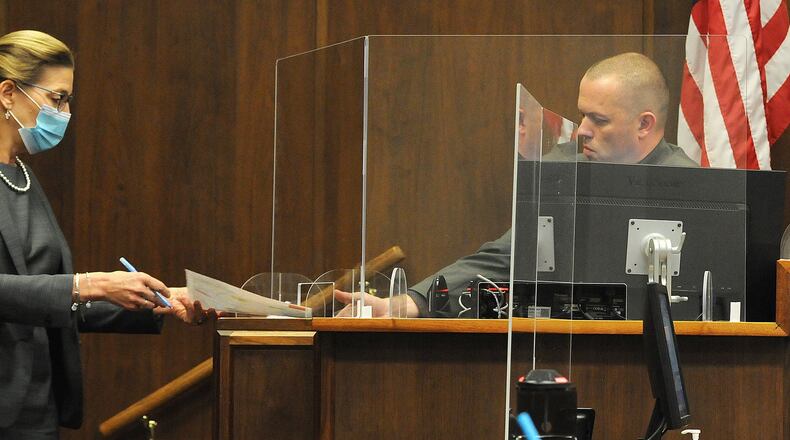 A Montgomery County assistant prosecutor asks questions to a Dayton Police detective this week during the county’s first jury trial since the coronavirus outbreak. MARSHALL GORBYSTAFF