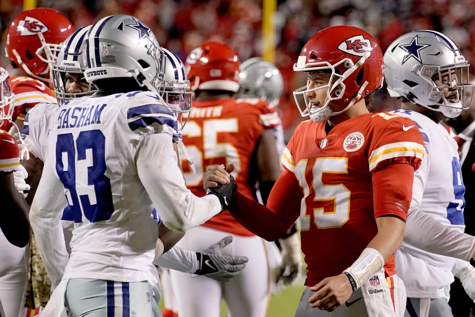 FILE - Kansas City Chiefs quarterback Patrick Mahomes (15) and Dallas Cowboys defensive end Tarell Basham (93) greet each other after an NFL football game, Sunday, Nov. 21, 2021, in Kansas City, Mo. (AP Photo/Charlie Riedel, File)