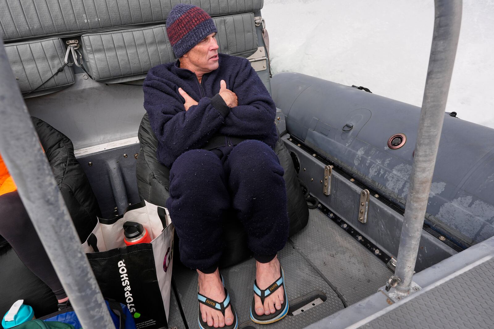Endurance swimmer Louis Pugh warms up on the ride back to shore after completing the first leg of his swim around Martha's Vineyard, Thursday, May 15, 2025, off Edgartown, Mass. (AP Photo/Robert F. Bukaty)