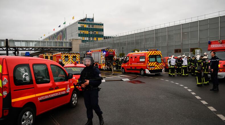 French policemen and firefighters secure the area at Paris' Orly airport on Saturday following the shooting of a man by French security forces.
Security forces at Paris' Orly airport shot dead a man who took a weapon from a soldier, the interior ministry said. Witnesses said the airport was evacuated following the shooting at around 8:30am (0730GMT). The man fled into a shop at the airport before he was shot dead, an interior ministry spokesman told AFP. He said no people were wounded in the incident.
