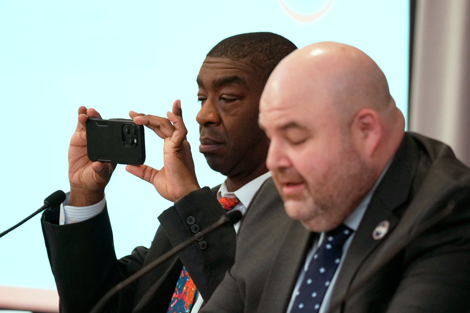 Commissioner Thomas Hicks takes a picture during the U.S. Election Assistance Commission Standards Board in-person public meeting, Thursday, April 24, 2025, in Charlotte, N.C. (AP Photo/Chris Carlson)