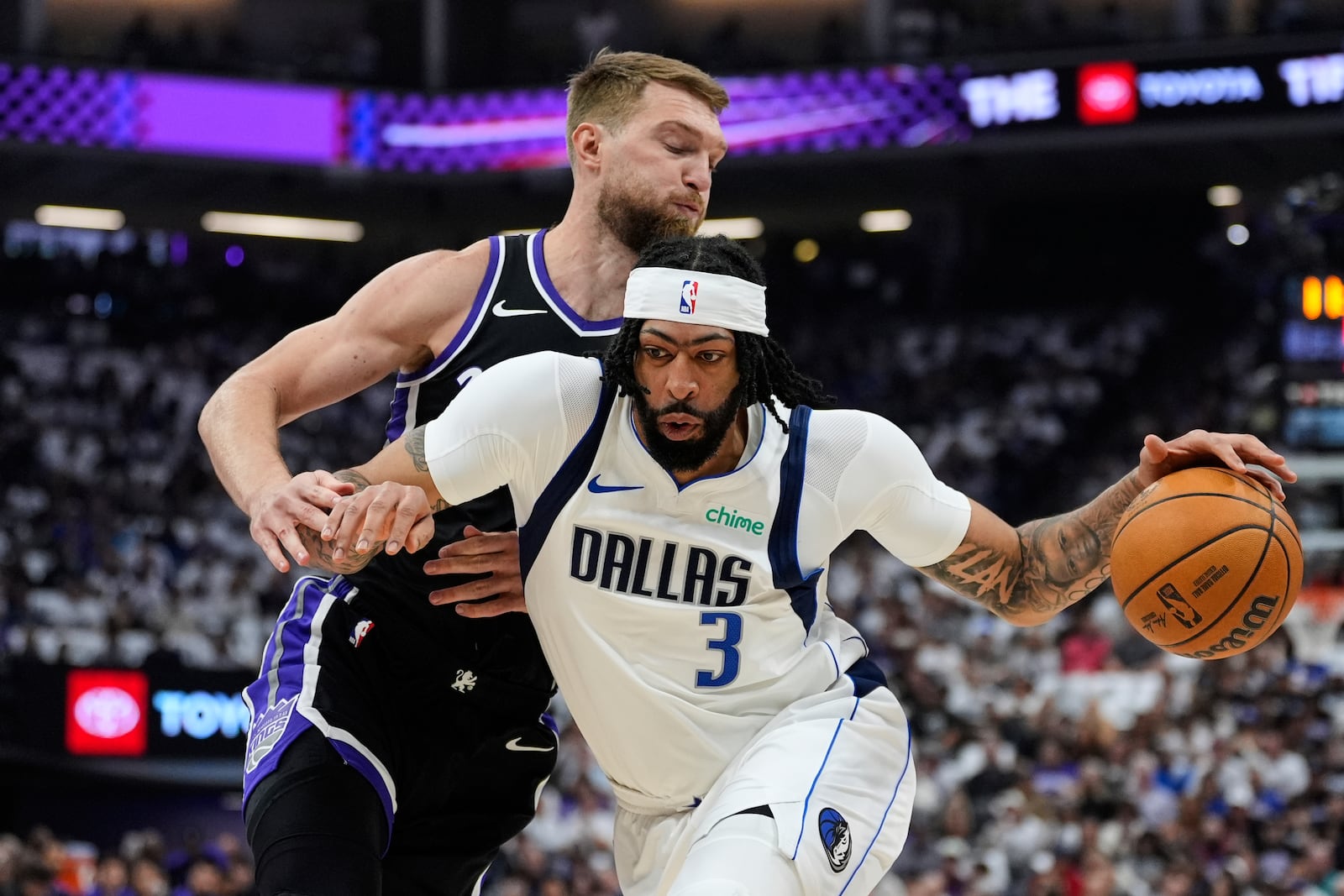 Dallas Mavericks forward Anthony Davis (3) moves the ball while defended by Sacramento Kings center Domantas Sabonis during the first half of an NBA play-in tournament basketball game Wednesday, April 16, 2025, in Sacramento, Calif. (AP Photo/Godofredo A. Vásquez)