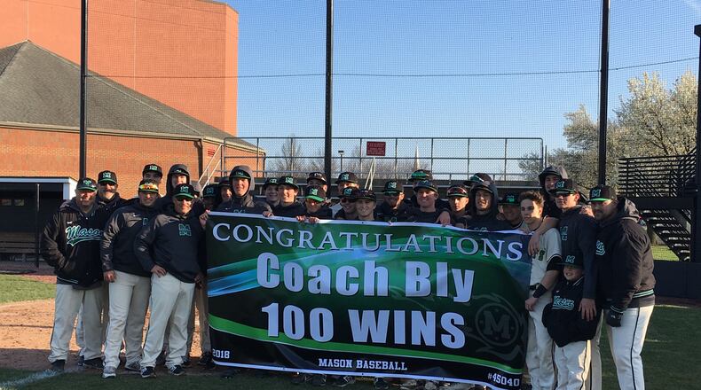 Mason’s baseball team celebrates head coach Curt Bly’s 100th career victory Tuesday after the Comets blanked visiting Hamilton 5-0. RICK CASSANO/STAFF