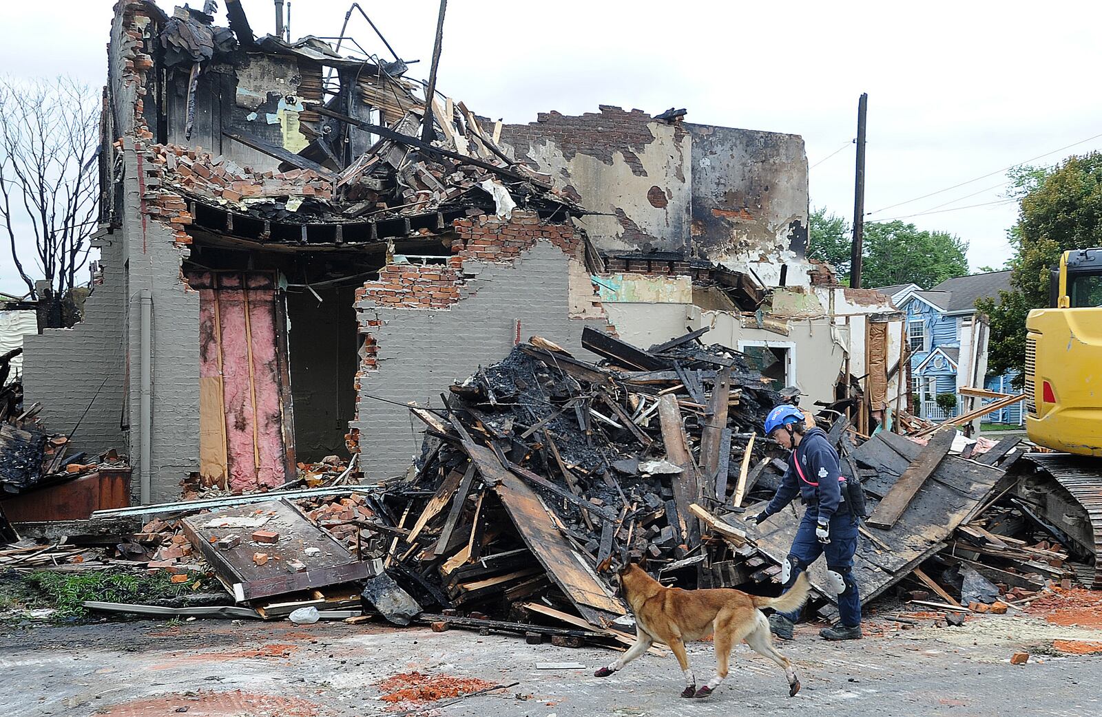 Fire destroyed three houses on East Fourth Street in Dayton Monday morning, June 6, 2024 resulting in an emergency demolition order. A cadaver dog was brought in from Columbus to check the ruins as a precaution. MARSHALL GORBY\STAFF