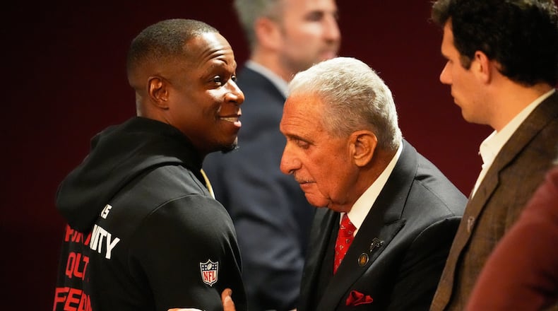 Atlanta Falcons owner Arthur Blank, right, hugs head coach Raheem Morris after an NFL football game against the New Orleans Saints, Sunday, Jan. 4, 2026, in Atlanta. (AP Photo/Mike Stewart)