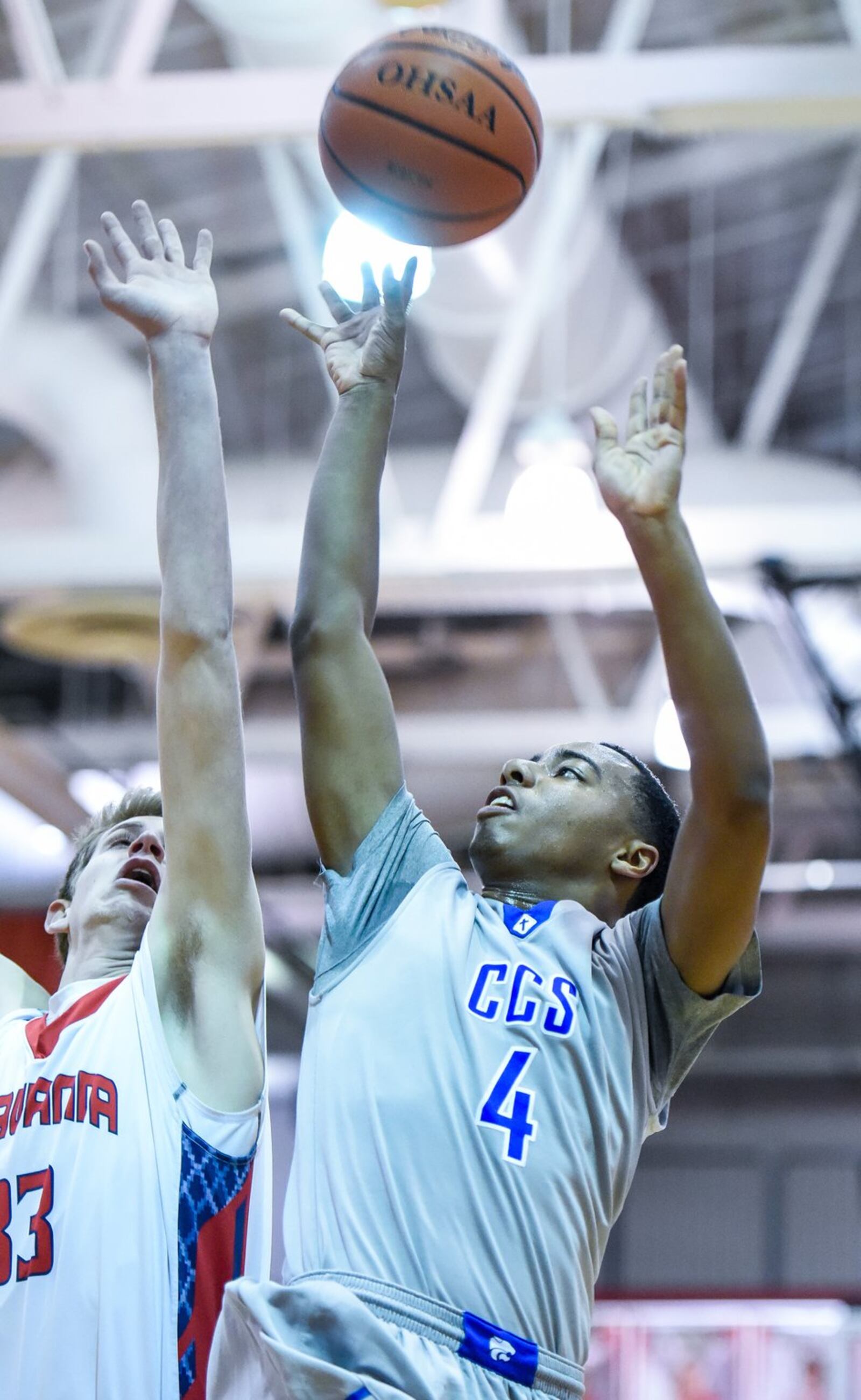 Cincinnati Christian’s Dylan Woods puts up a shot as Talawanda’s Josh DeWitt defends during their game in the Brian Cook Classic on Thursday night at Madison. NICK GRAHAM/STAFF