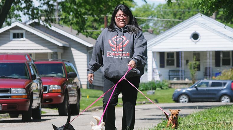 FILE PHOTO" Sara Llamas walks her dogs along Corinth Boulevard on a beautiful but chilly Monday morning. Llamas’ dogs are (from left) Aislyn, Piper and Nova. (Marshall Gorby/Staff)
