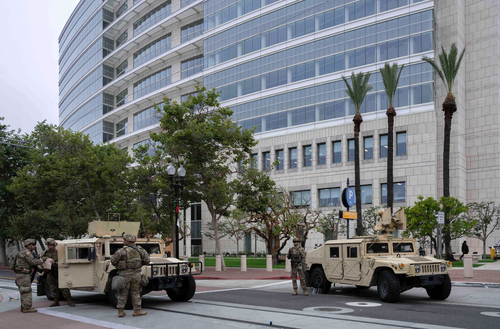 The California National Guard arrives to stand watch outside the Ronald Reagan Federal Building and Courthouse in Santa Ana, Calif., Tuesday, June 10, 2025, after Monday's protests against President Trump's ICE raids resulted in violence. (Mindy Schauer /The Orange County Register via AP)