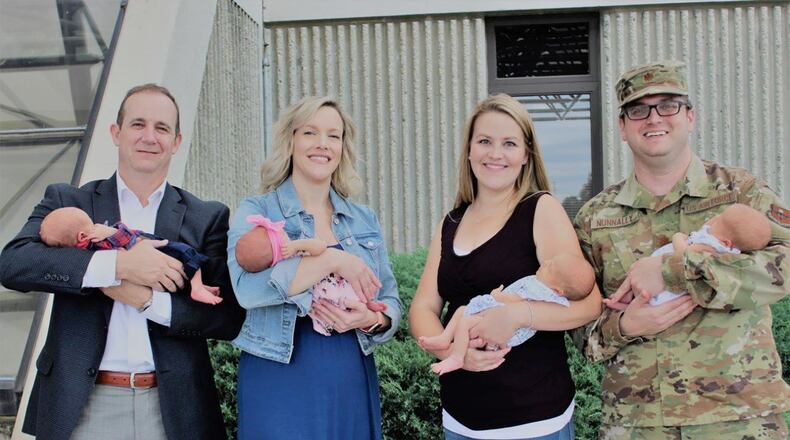 Dale and Crissi Kolomaznik (left) and Katie and Maj. Beau Nunnally (right) reunite at the Wright-Patterson Medical Center with their twins who were delivered at the center in mid August. (Contributed photo)