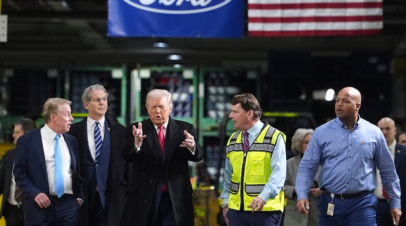 President Donald Trump speaks to, from left Bill Ford, Executive Chairman of Ford, Treasury Secretary Scott Bessent, Jim Farley, CEO of Ford, and Corey Williams, Ford River Rouge Plant Manager, during a tour of the Ford River Rogue complex, Tuesday, Jan. 13, 2026, in Dearborn, Mich. (AP Photo/Evan Vucci)