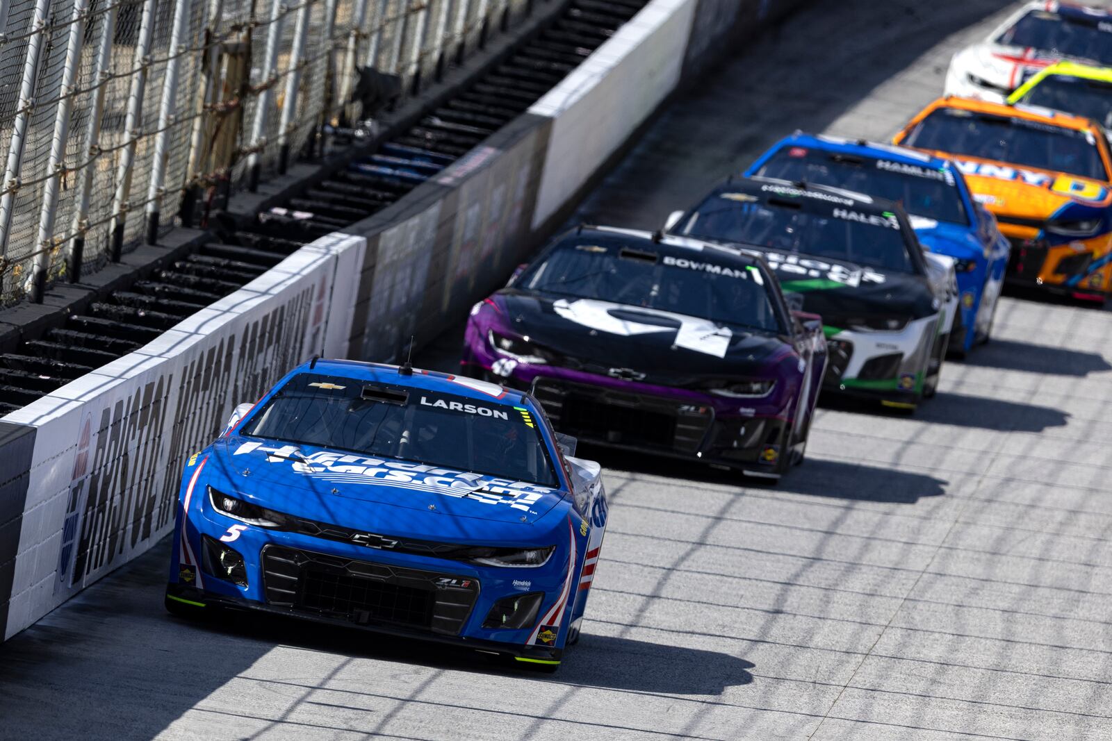 Kyle Larson (5) leads Alex Bowman (48) and others during a NASCAR Cup Series auto race, Sunday, April 13, 2025, in Bristol, Tenn. (AP Photo/Wade Payne)