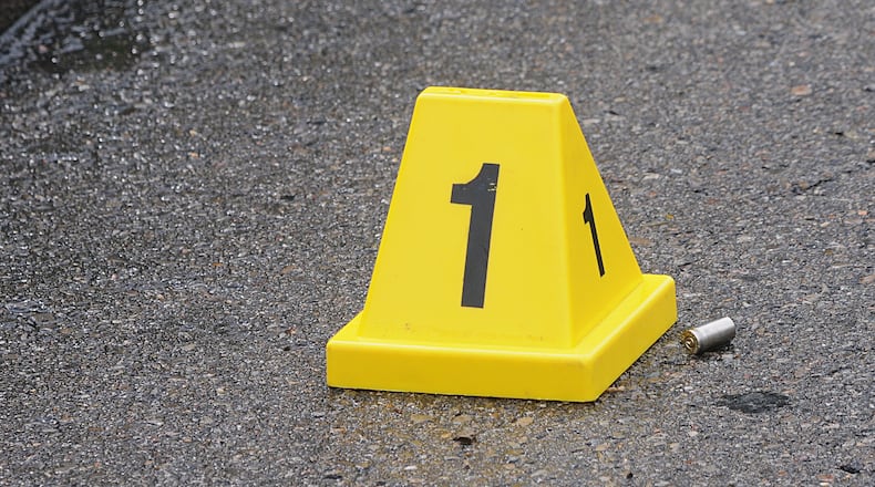 Police placed evidence markers where spent shell casings were found along the west side of North Main Street at West Shadyside Drive, Dayton Monday May 9, 2016. (Marshall Gorby/Staff)