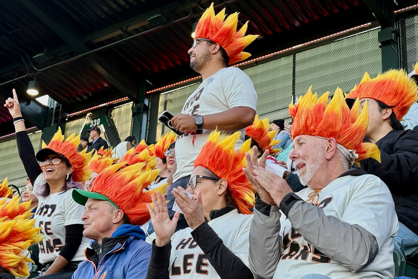 Fans of San Francisco Giants' Jung Hoo Lee, who call themselves Hoo Lee Gans, watch during a baseball game between the Giants and the Arizona Diamondbacks in San Francisco, Tuesday, May 13, 2025. (AP Photo/Haven Daley)