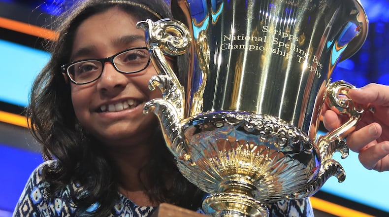 Ananya Vinay, 12, from Fresno, Calif., holds the trophy after being declared the winner of last year’s Scripps National Spelling Bee, in Oxon Hill, Md. The third round for this year’s bee begins Wednesday with 452 spellers still alive in the competition. (AP Photo/Manuel Balce Ceneta)