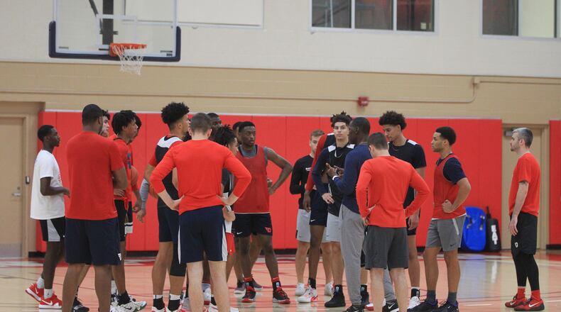 Dayton huddles around Anthony Grant at the last practice of the summer on Thursday, July 22, 2021, at the Cronin Center. David Jablonski/Staff