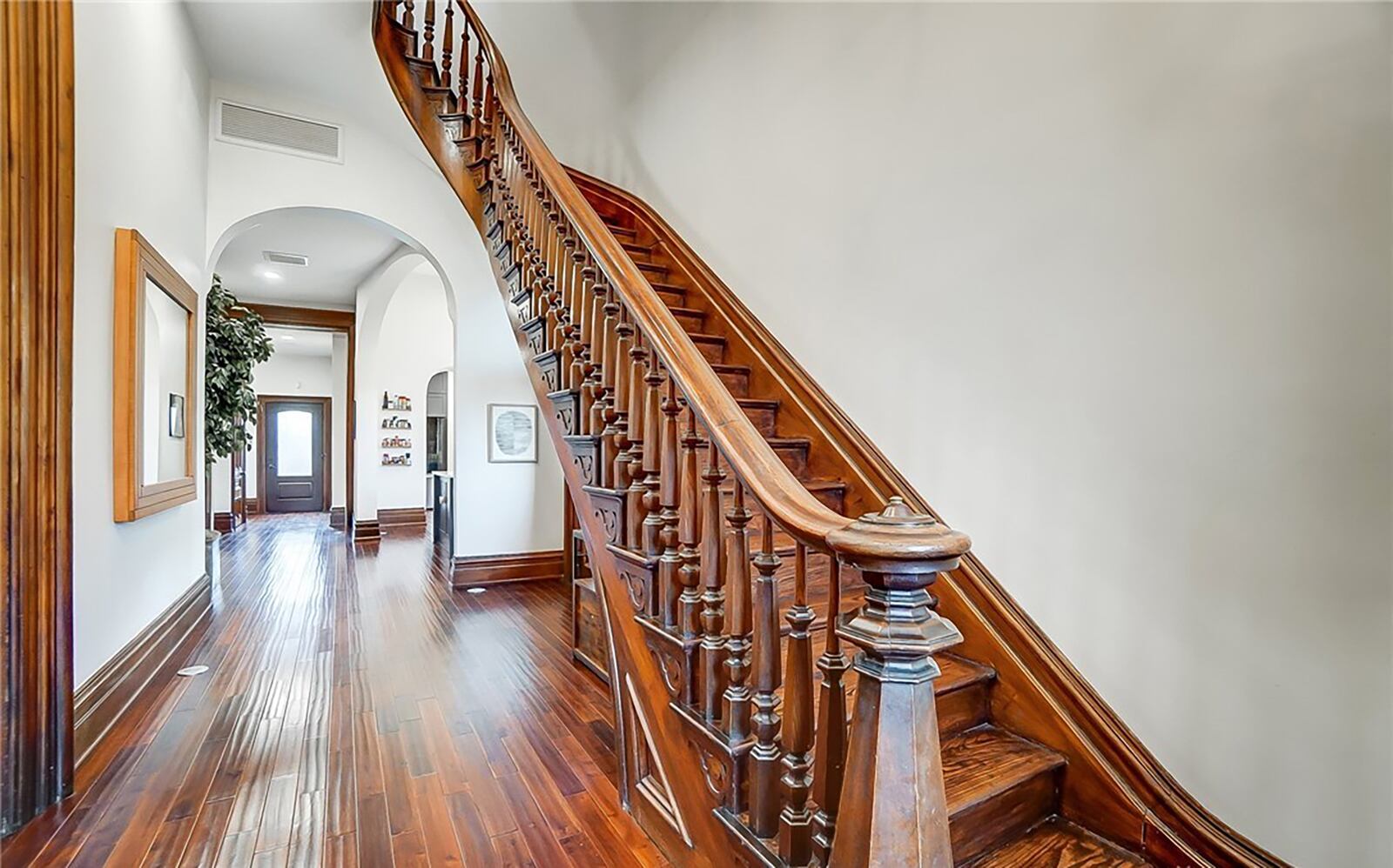 The grand staircase spirals up to the second and third levels and has intricate carvings and designs.