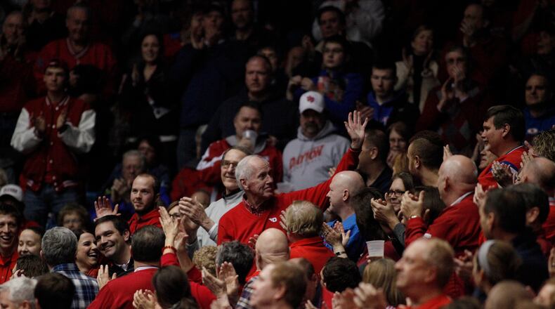 Former Dayton coach Don Donoher waves to the crowd during a game against St. Joseph’s on Thursday, Feb. 19, 2015, at UD Arena. David Jablonski/Staff