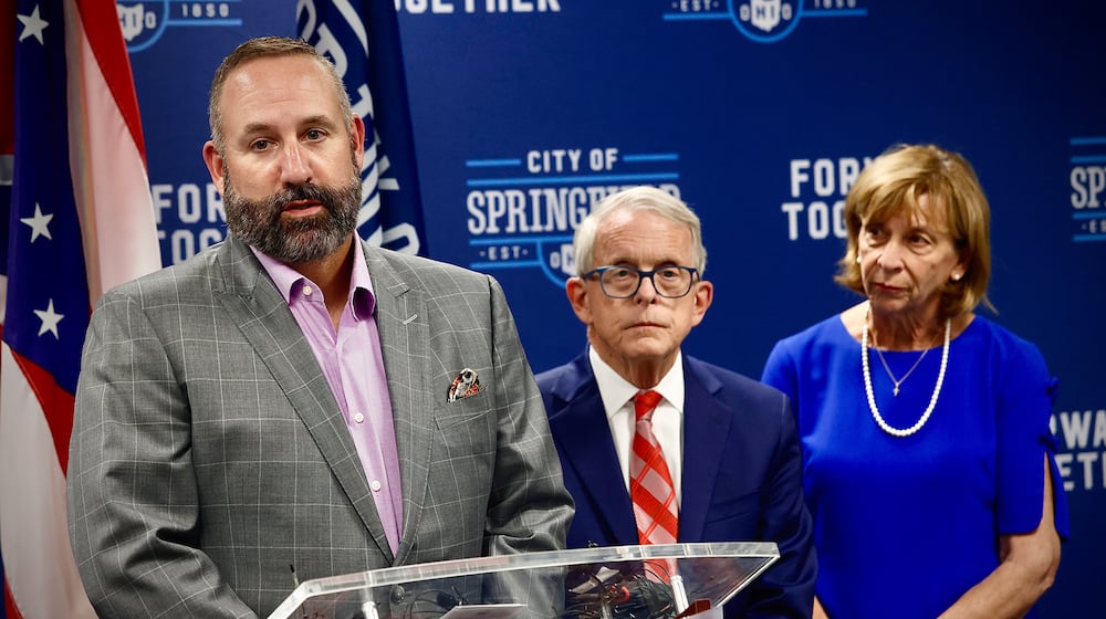 The city of Springfield School District Superintendent Dr. Robert Hill, with Ohio Governor Mike DeWine, and his wife Fran, answer questions at a press conference Tuesday, September 17, 2024 at City Hall in Springfield. MARSHALL GORBY / STAFF