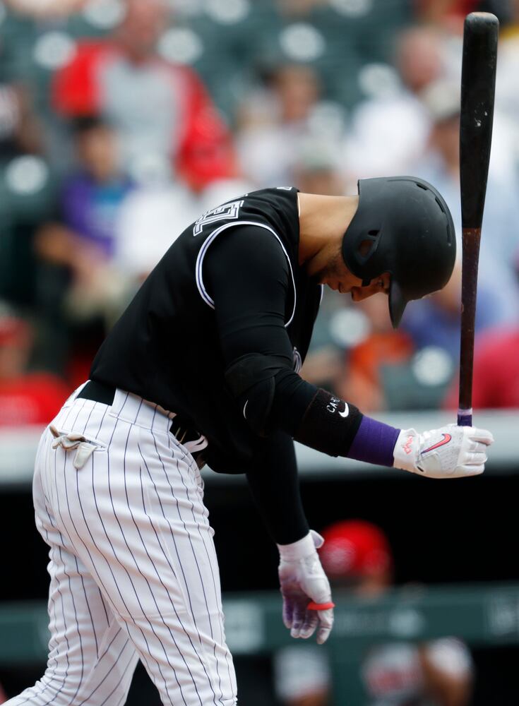 PHOTOS: Reds pile up 13 hits, beat the Rockies