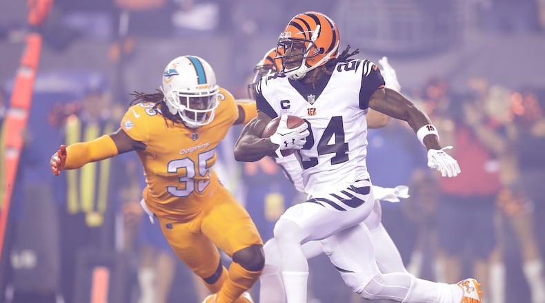Walt Aikens of the Dolphins attempts to tackle Adam Jones of the Bengals during a game at Paul Brown Stadium on last season.