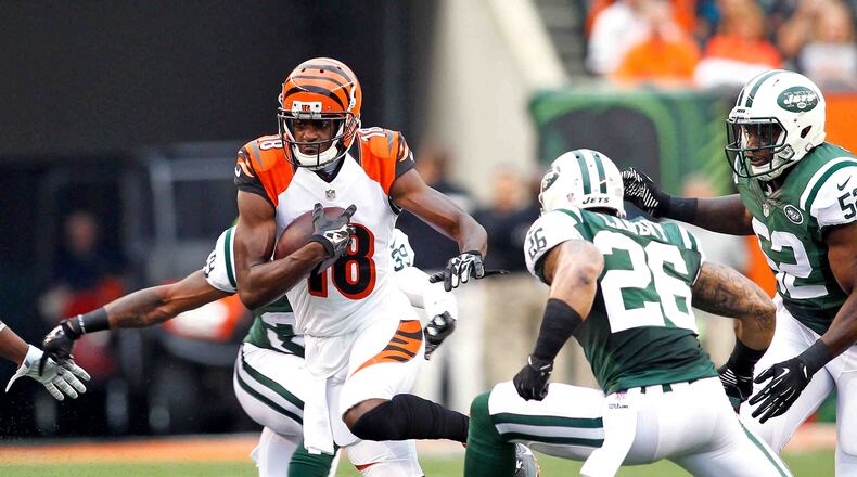 Cincinnati Bengals wide receiver A.J. Green (18) runs after a catch in Saturday night's preseason game against the Jets Aug. 16, 2014, at Paul Brown Stadium in Cincinnati. NICK DAGGY / STAFF