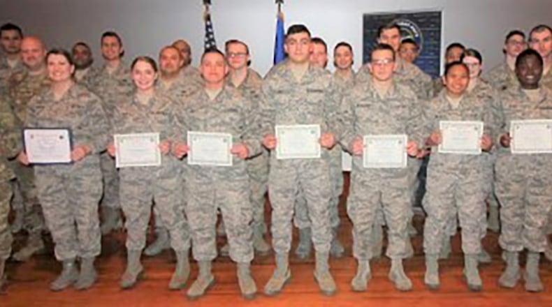 Col. Tom Sherman (left), 88th Air Base Wing and installation commander, and Chief Master Sgt. Stephen Arbona (back right), 88th Air Base Wing command chief, celebrate the newest Team Wright-Patt enlisted promotees during a ceremony at the Wright-Patterson Base Theater, Jan. 31. (U.S. Air Force photo/Thomas Lewis)