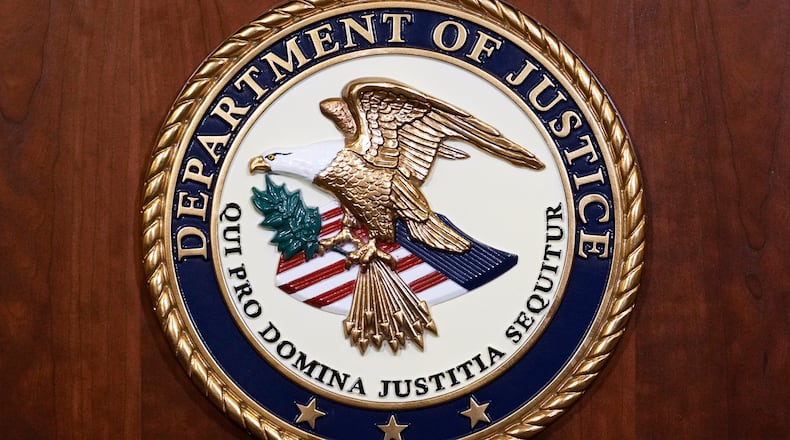 FILE - The seal of the Dept of Justice is shown on the podium, Aug. 1, 2023, at an office of the Department of Justice in Washington. (AP Photo/J. Scott Applewhite, File)