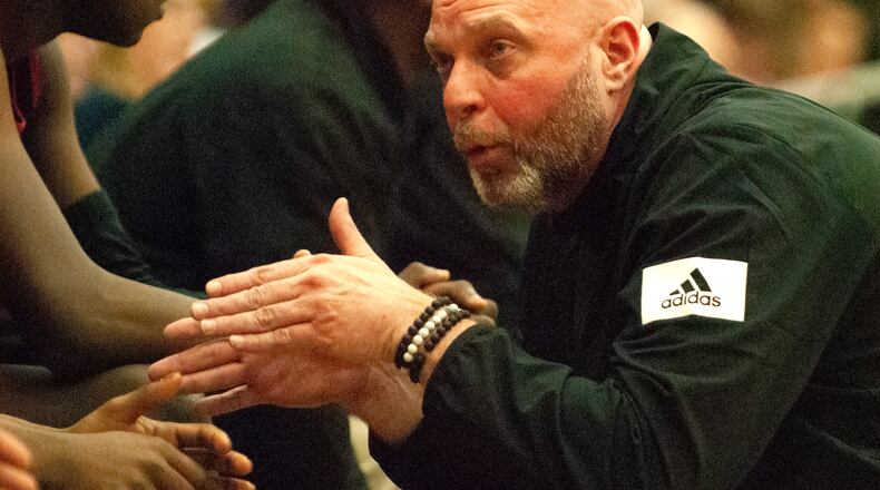 Trotwood-Madison coach Rocky Rockhold talks to players on his bench during the second half of Sunday’s Flyin’ To The Hoop game at Trent Arena against Akron St. Vincent-St. Mary. Jeff Gilbert/CONTRIBUTED