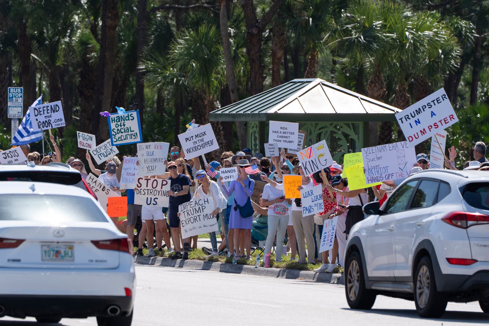 Activists protest President Donald Trump, who was a few miles away at his Trump National Golf Club, during a "Hands Off!" demonstration Saturday, April 5, 2025, in Palm Beach Gardens, Fla. (AP Photo/Alex Brandon)