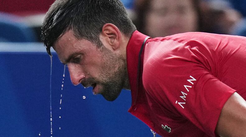 FILE - Novak Djokovic of Serbia cools himself with water during the men's singles semifinal match with Valentin Vacherot of Monaco, at the Shanghai Masters tennis tournament at Qizhong Forest Sports City Tennis Center, in Shanghai, China, Saturday, Oct. 11, 2025. (AP Photo/Andy Wong,File)