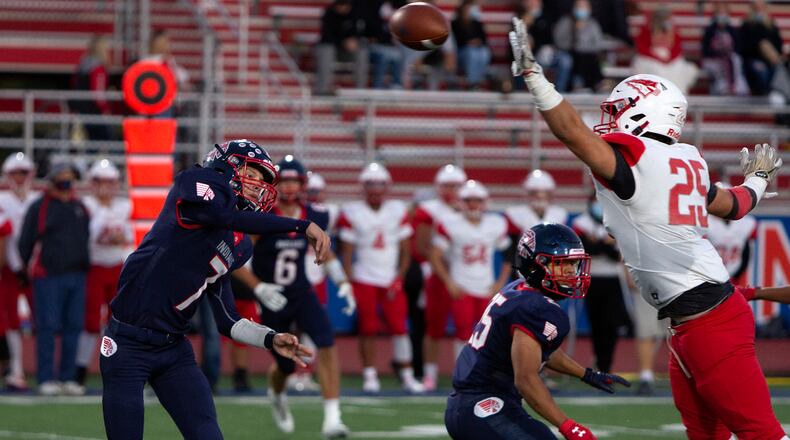 Piqua quarterback Brady Ouhl fires a pass past Stebbins' Dalton King during Piqua's 27-0 victory over Stebbins on Friday, Sept. 18, 2020. Jeff Gilbert/CONTRIBTED